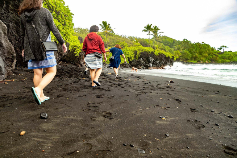 black sand beach visitors walking waianapanapa road to hana maui feature