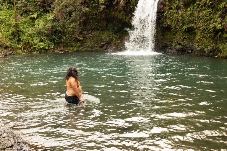 swimmer and waterfall at puaa kaa state park